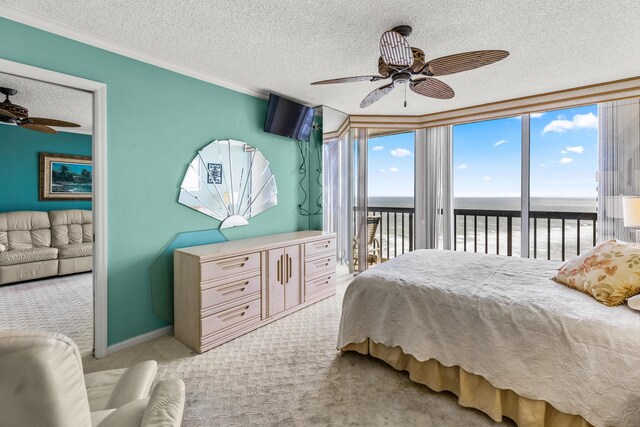 9500 S Ocean Dr Unit 1909, Jensen Beach, FL 34957 - bedroom with access to exterior, carpet floors, a textured ceiling, crown molding, and ceiling fan