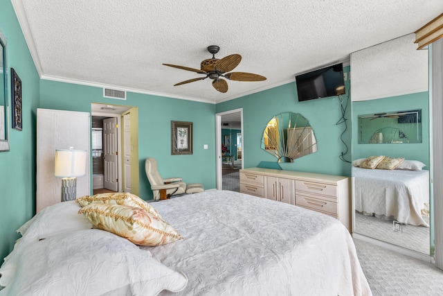 carpeted bedroom featuring ceiling fan, a textured ceiling, and ornamental molding