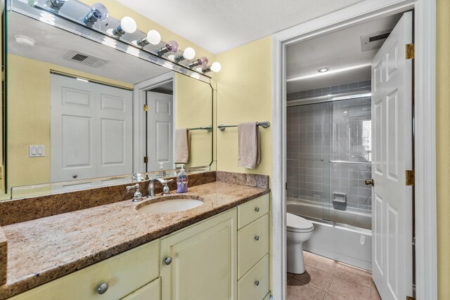 9500 S Ocean Dr Unit 1909, Jensen Beach, FL 34957 - full bathroom featuring toilet, vanity, tile patterned flooring, and shower / bath combination with glass door