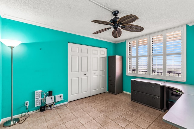 unfurnished office featuring crown molding, a textured ceiling, light tile patterned floors, and ceiling fan