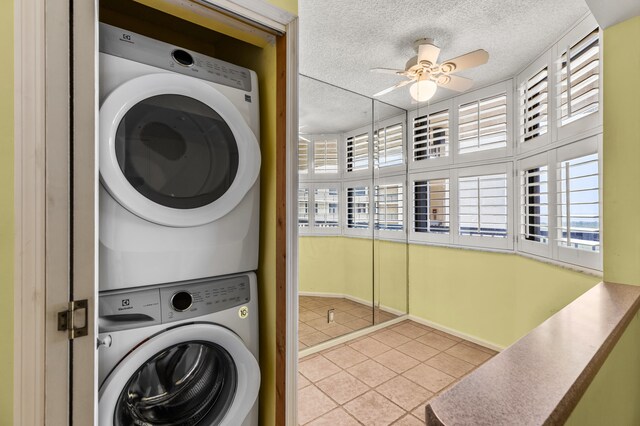 9500 S Ocean Dr Unit 1909, Jensen Beach, FL 34957 - laundry area featuring stacked washing machine and dryer, tile patterned floors, a textured ceiling, a ceiling fan, and healthy amount of natural light