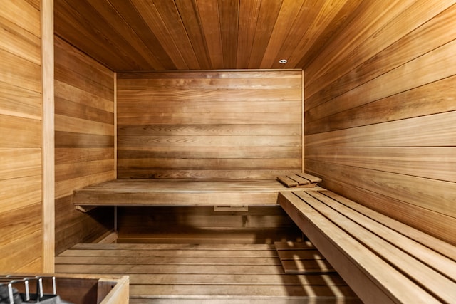 view of sauna with wood ceiling and wood walls