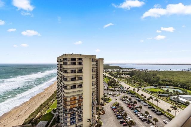 exterior space featuring a water view and a beach view