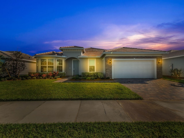 view of front of property with a lawn and a garage