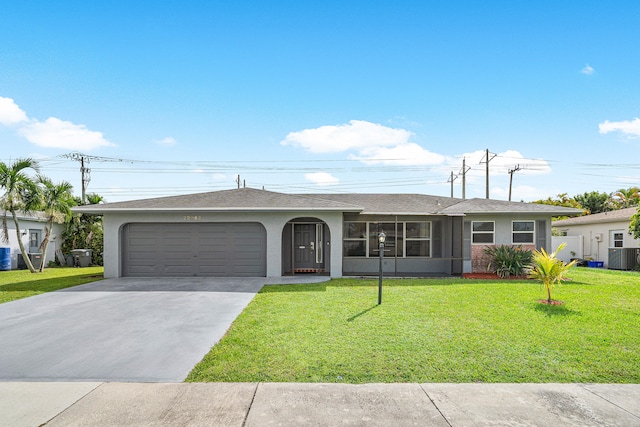 ranch-style home with a front yard, a garage, and central air condition unit