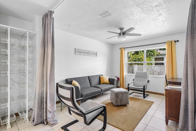 tiled living room featuring a textured ceiling and ceiling fan