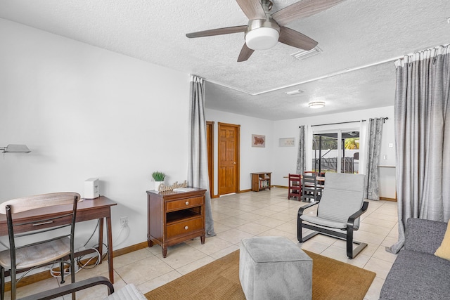 tiled living room featuring ceiling fan and a textured ceiling