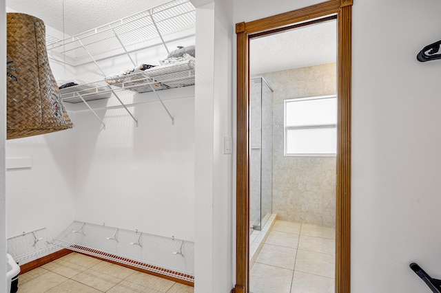 walk in closet with tile patterned floors