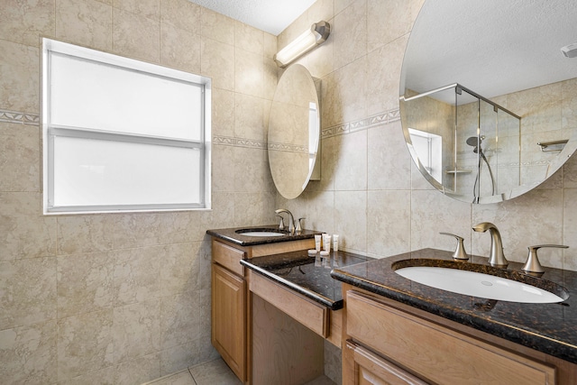 bathroom with vanity, tile walls, and walk in shower