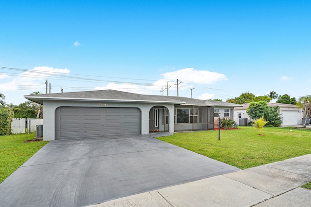 single story home featuring a front yard and a garage