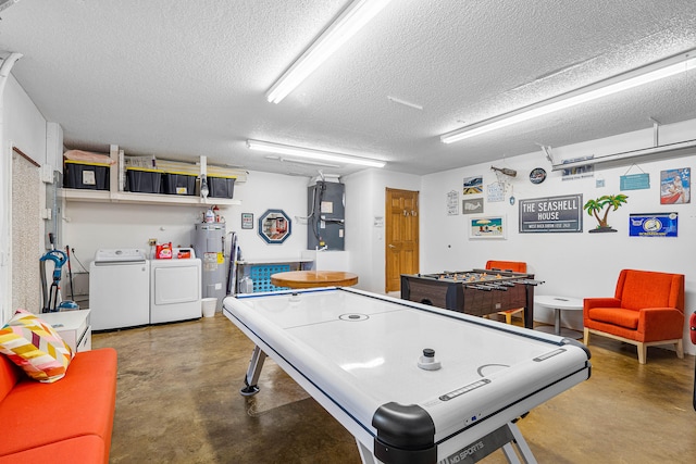 rec room with a textured ceiling, washer and clothes dryer, water heater, and concrete flooring