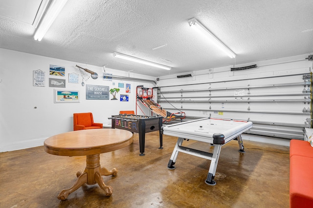 game room with concrete floors and a textured ceiling