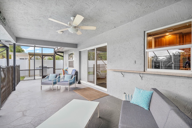 sunroom featuring ceiling fan