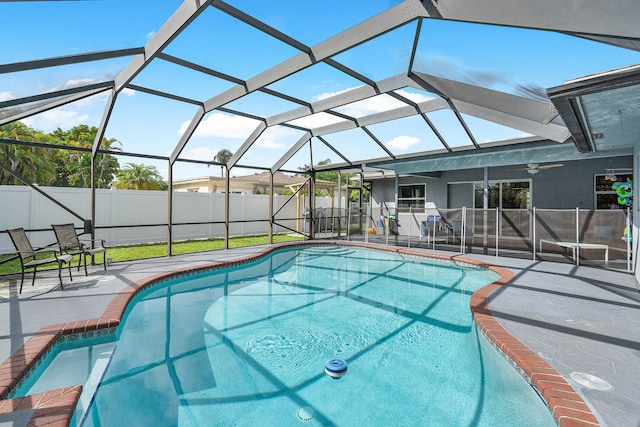 view of swimming pool featuring a patio area and glass enclosure