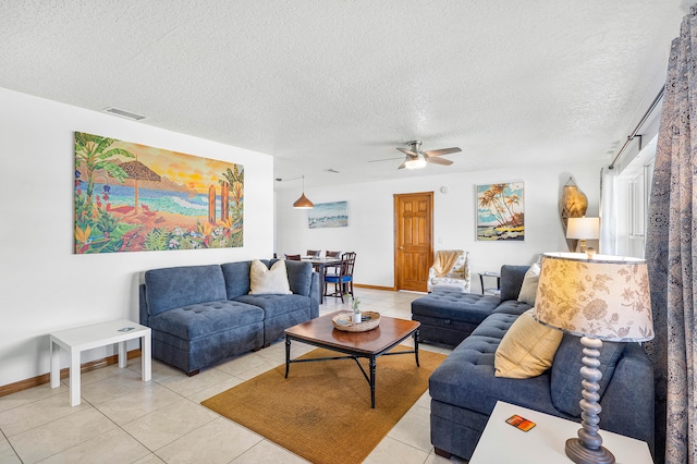 tiled living room featuring a textured ceiling and ceiling fan