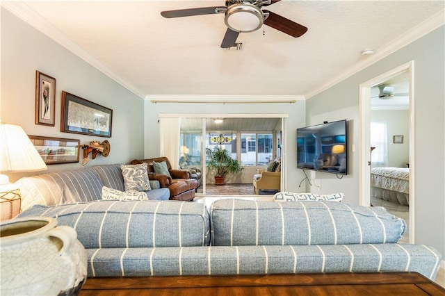 living room with ceiling fan, ornamental molding, and wood-type flooring