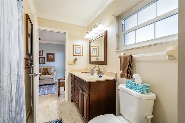 bathroom with vanity, toilet, and ornamental molding