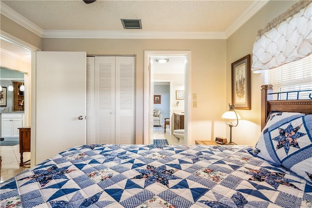 unfurnished bedroom featuring crown molding, a closet, and ensuite bath