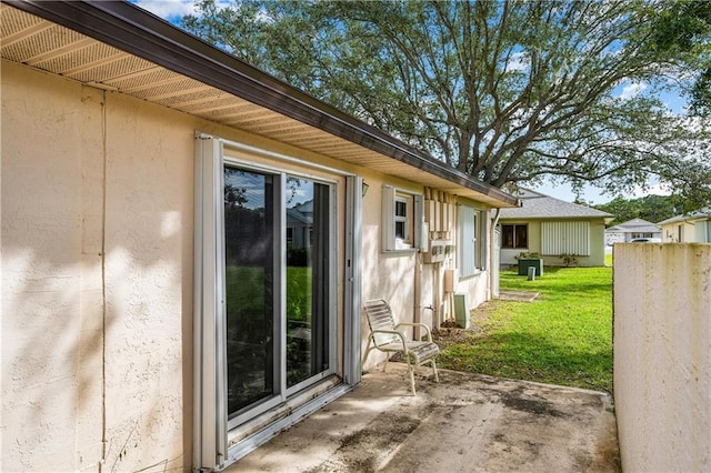 view of side of property featuring a yard and a patio