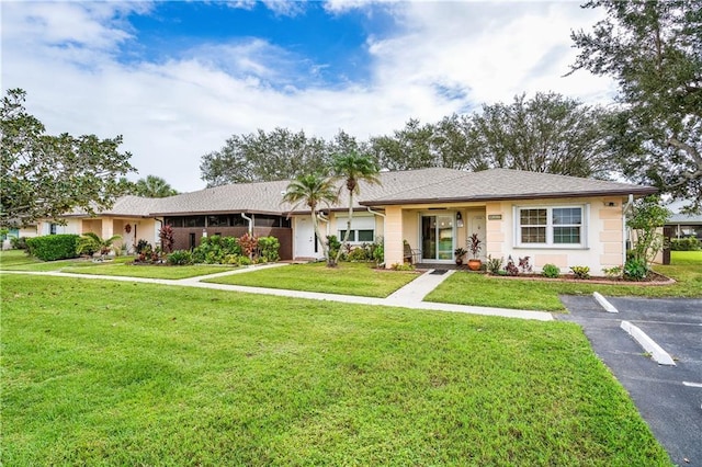 ranch-style house with a front lawn