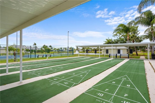 view of property's community featuring tennis court