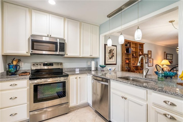 kitchen featuring sink, hanging light fixtures, white cabinetry, stainless steel appliances, and crown molding