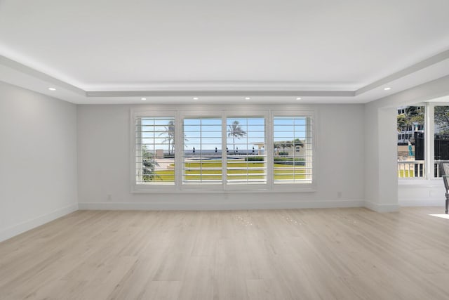 600 S Ocean Blvd Unit 103, Boca Raton, FL 33432 - unfurnished room with a raised ceiling, a healthy amount of sunlight, and light wood finished floors