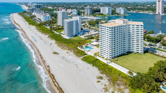 drone / aerial view featuring a water view and a beach view