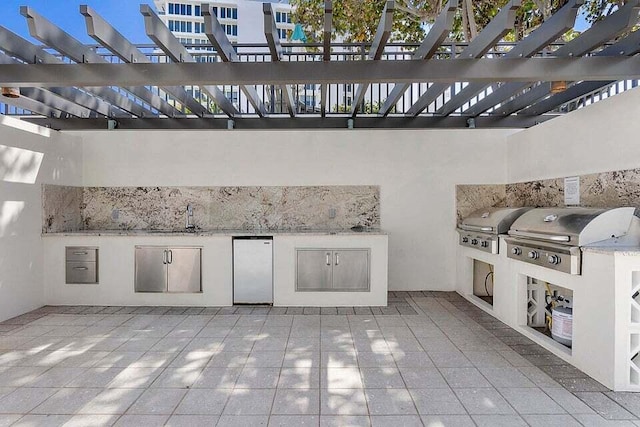 view of patio / terrace with area for grilling and a pergola