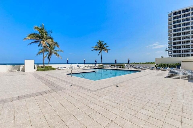 view of pool with a water view