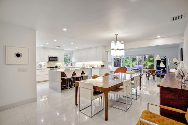 tiled dining area with a notable chandelier