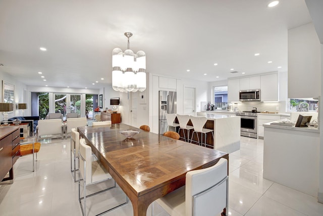 dining area featuring a notable chandelier and light tile patterned floors