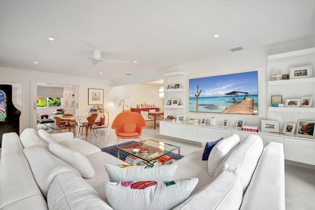 living room featuring built in features and ceiling fan