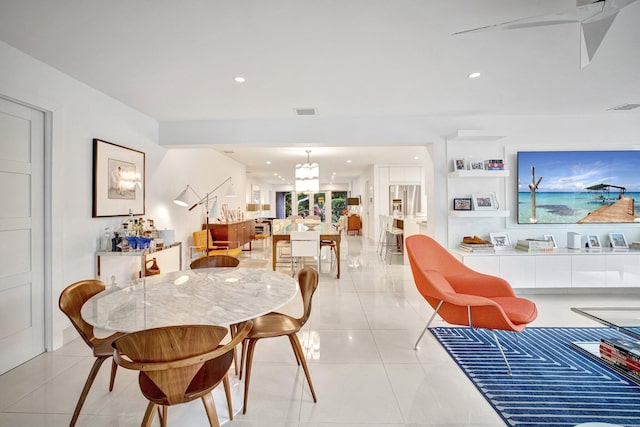 tiled dining area with an inviting chandelier