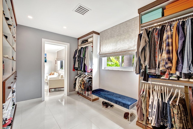 spacious closet with light tile patterned floors