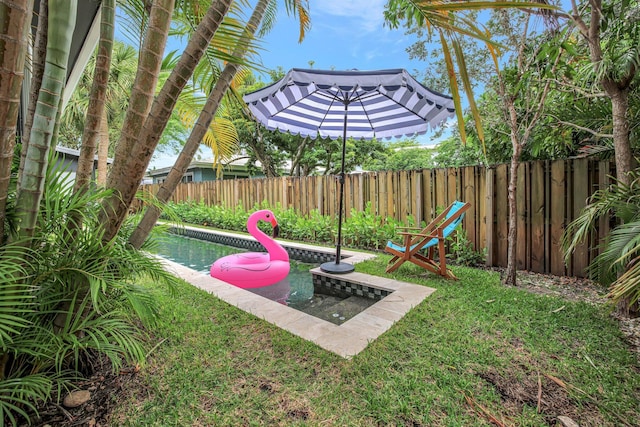 view of yard with a fenced in pool