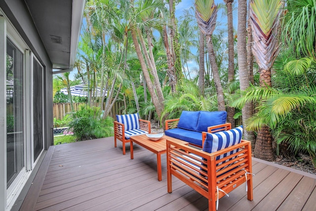 wooden terrace with an outdoor living space