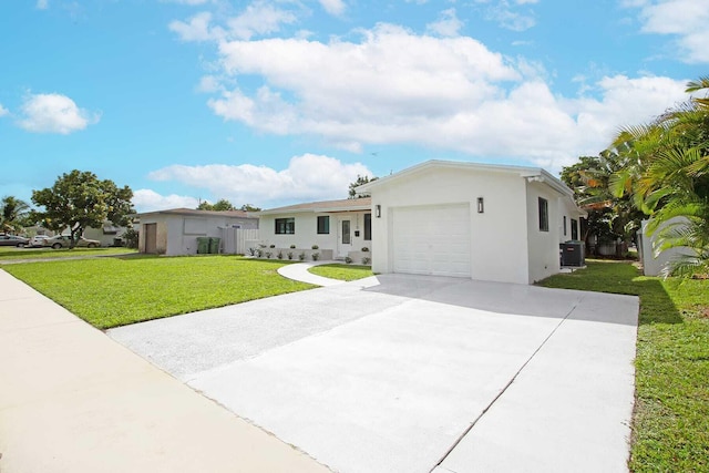 ranch-style home with a front yard, a garage, and central AC unit