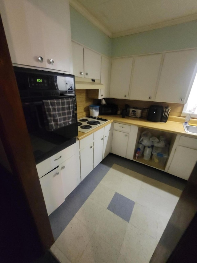 kitchen with white cabinetry, oven, white electric cooktop, and crown molding