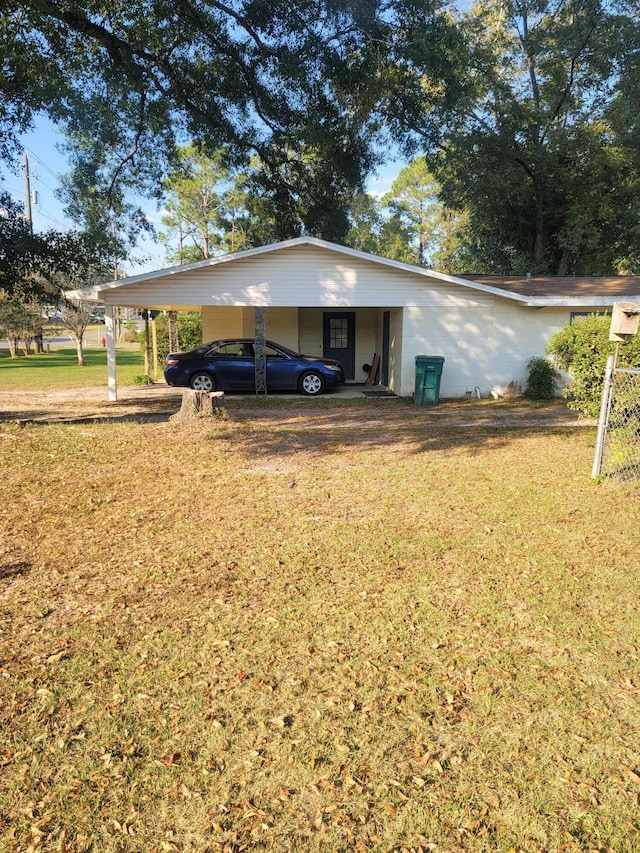 exterior space with a yard and a carport