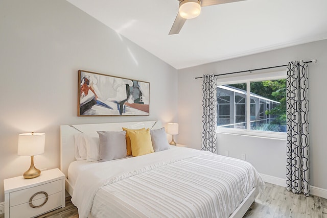 bedroom with vaulted ceiling, ceiling fan, and light hardwood / wood-style flooring