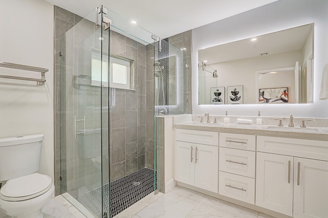 bathroom featuring walk in shower, vanity, and toilet