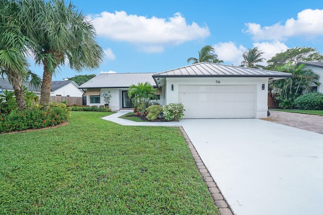 ranch-style home featuring a garage and a front yard