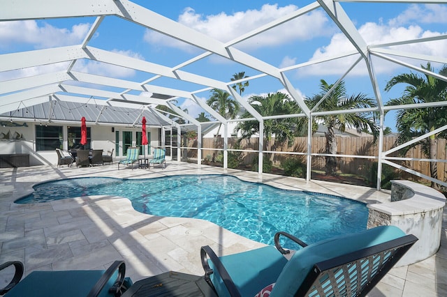 view of swimming pool with a patio and a lanai