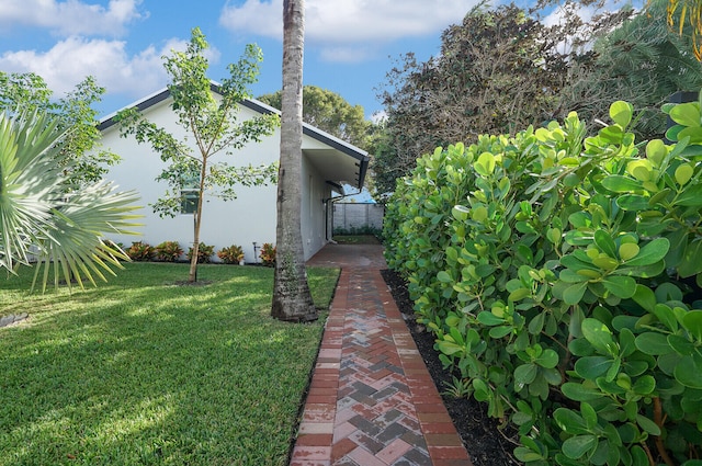 view of property exterior with a lawn