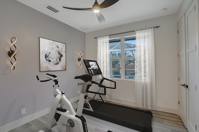 workout room with light hardwood / wood-style floors and ceiling fan