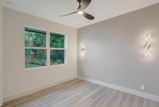 spare room with light wood-type flooring and ceiling fan