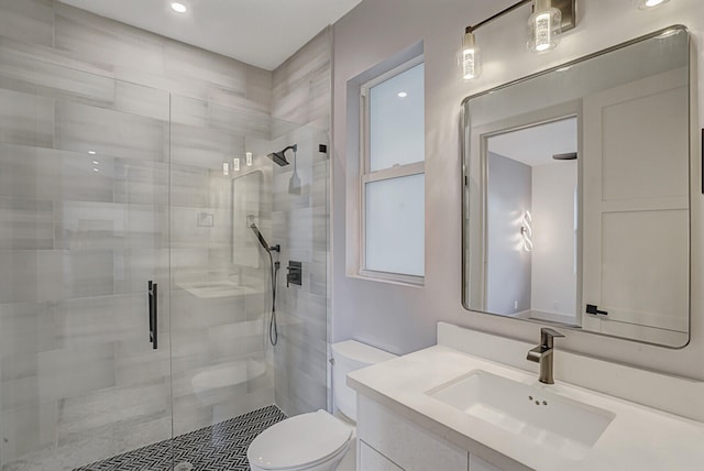 bathroom with vanity, toilet, and an enclosed shower