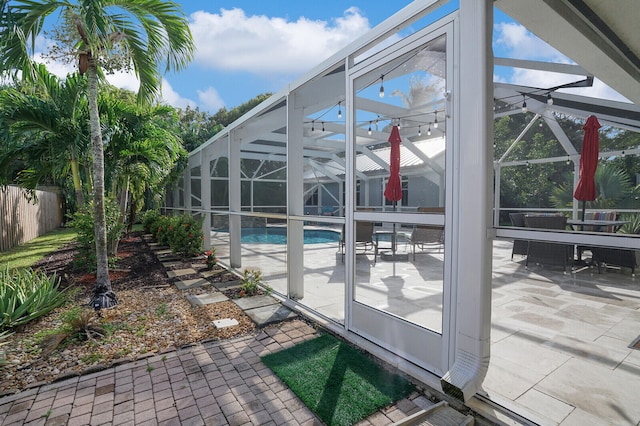 exterior space featuring glass enclosure and a patio area