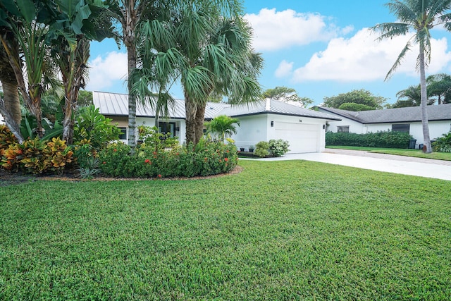 view of front of home with a front lawn and a garage